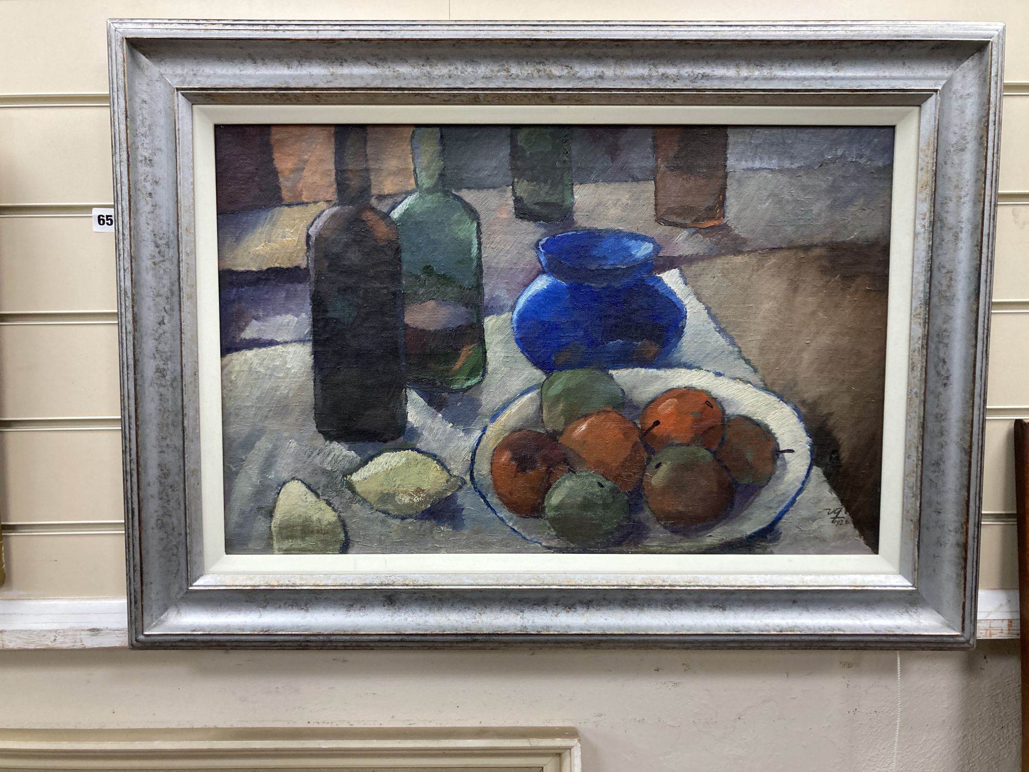 French School c.1928, oil on canvas, Still life of fruit and bottles on a table top, initialled and dated 1928, 39 x 60cm